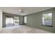 Bedroom featuring a ceiling fan, sliding glass doors to the pool, and a large window at 2932 Sweetgum S Way, Clearwater, FL 33761
