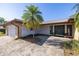 Front entrance with brick pavers, beautiful front door, palm tree, and two-car garage at 2932 Sweetgum S Way, Clearwater, FL 33761