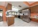 Bright kitchen with stainless steel refrigerator, breakfast bar and wood cabinets at 2932 Sweetgum S Way, Clearwater, FL 33761