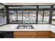 Kitchen sink in front of a large window overlooking the screened in pool at 2932 Sweetgum S Way, Clearwater, FL 33761