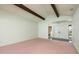 Living room with open entryway, vaulted ceilings, exposed beams, and views of the front entryway at 2932 Sweetgum S Way, Clearwater, FL 33761