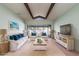 Staged living room with vaulted ceilings, comfortable seating, stylish décor, and sliding glass doors to the pool at 2932 Sweetgum S Way, Clearwater, FL 33761