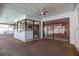 A covered patio area with a pass-through to the kitchen overlooks the pool at 2932 Sweetgum S Way, Clearwater, FL 33761