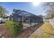 Enclosed backyard pool with screened enclosure and a well-manicured perimeter hedge for added privacy at 2932 Sweetgum S Way, Clearwater, FL 33761