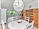 Bright dining area with stylish light fixture, wooden bookcase, and open floor plan at 2960 59Th S St # 102, Gulfport, FL 33707