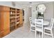 Open dining area featuring tile floors, a wooden bookcase, and bright natural light at 2960 59Th S St # 102, Gulfport, FL 33707