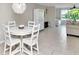 Inviting dining room with a white table, chairs, and decorative lighting at 2960 59Th S St # 102, Gulfport, FL 33707