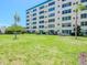 A multi-story building with lush green lawn and mature palm trees at 2960 59Th S St # 102, Gulfport, FL 33707