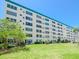 Exterior view of a well-maintained building with manicured green lawns at 2960 59Th S St # 102, Gulfport, FL 33707