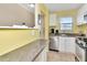 Cozy kitchen featuring stainless steel appliances, a breakfast bar, and ample counter space at 2960 59Th S St # 102, Gulfport, FL 33707