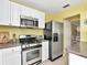 Modern kitchen with stainless steel appliances, white cabinets, and stylish countertops at 2960 59Th S St # 102, Gulfport, FL 33707