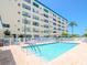 Community pool with lounge chairs and building view at 2960 59Th S St # 102, Gulfport, FL 33707