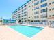 Community pool with various lounge chairs and tables, perfect for entertaining at 2960 59Th S St # 102, Gulfport, FL 33707
