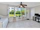Bright sunroom with a ceiling fan and large windows showcasing a view of the lush outdoors at 2960 59Th S St # 102, Gulfport, FL 33707