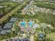 Aerial view of community featuring a pool, clubhouse, playground, tennis and sports courts at 3211 Grassglen Pl, Wesley Chapel, FL 33544