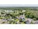 Gorgeous aerial view of homes in a landscaped community, close to a lake and surrounded by trees at 3211 Grassglen Pl, Wesley Chapel, FL 33544