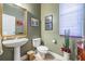 Half bathroom with a pedestal sink, toilet, and stylish decor at 3211 Grassglen Pl, Wesley Chapel, FL 33544