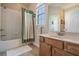 Bathroom featuring a tub with shower and a vanity with storage at 3211 Grassglen Pl, Wesley Chapel, FL 33544