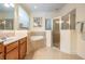 Bathroom featuring a tile-surround soaking tub, glass-enclosed shower, and vanity with storage at 3211 Grassglen Pl, Wesley Chapel, FL 33544