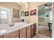 Bathroom featuring double vanities and a doorway leading to another room at 3211 Grassglen Pl, Wesley Chapel, FL 33544