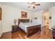 Primary bedroom featuring hardwood floors, ceiling fan, and nightstands at 3211 Grassglen Pl, Wesley Chapel, FL 33544