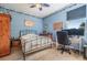 Bedroom featuring a bed, a desk with a computer, and nautical-themed decor at 3211 Grassglen Pl, Wesley Chapel, FL 33544