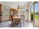 Inviting breakfast area with a round table, chairs, and natural light from sliding glass doors at 3211 Grassglen Pl, Wesley Chapel, FL 33544
