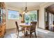 Sunlit breakfast area featuring a wood table, chairs, a chandelier and a sliding glass door at 3211 Grassglen Pl, Wesley Chapel, FL 33544