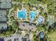 Aerial view of a community center featuring pools, tennis courts, basketball court and more surrounded by lush landscaping at 3211 Grassglen Pl, Wesley Chapel, FL 33544