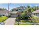Charming two-story home with a well-manicured lawn, mature landscaping, and an attached two-car garage at 3211 Grassglen Pl, Wesley Chapel, FL 33544