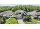 Two-story home featuring a well-kept lawn, mature trees, and a two-car garage in a residential neighborhood at 3211 Grassglen Pl, Wesley Chapel, FL 33544