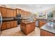 Spacious kitchen featuring wooden cabinetry, granite countertops and stainless steel appliances at 3211 Grassglen Pl, Wesley Chapel, FL 33544