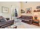 Cozy living room with tile floors, comfortable seating, and natural light from the window at 3211 Grassglen Pl, Wesley Chapel, FL 33544