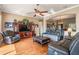 Relaxing living room featuring hardwood floors, comfortable leather furniture, and elegant decor at 3211 Grassglen Pl, Wesley Chapel, FL 33544
