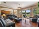 Comfortable living room with wood floors, a ceiling fan, and sliding glass doors to the patio at 3211 Grassglen Pl, Wesley Chapel, FL 33544
