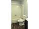 Standard bathroom featuring a toilet, sink with vanity, and tiled bathtub at 3321 Laurel View Dr, Brandon, FL 33511