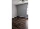 Simple bedroom with hardwood floors, neutral walls, and a window at 3321 Laurel View Dr, Brandon, FL 33511