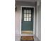Close-up of the home's front door, featuring a windowed design and 'Wipe Your Paws' doormat at 3321 Laurel View Dr, Brandon, FL 33511