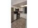 Updated kitchen featuring stainless steel appliances, white cabinets, and modern backsplash at 3321 Laurel View Dr, Brandon, FL 33511