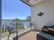 Relaxing balcony with comfortable seating, views of the river, boats, dock, and lush greenery at 362 Coquina Dr, Tarpon Springs, FL 34689