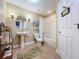 Well-lit bathroom with pedestal sink, framed mirror, and shower-tub combination at 362 Coquina Dr, Tarpon Springs, FL 34689