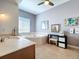 Bright bathroom showcasing a soaking tub, vanity with a sink, and neutral tile flooring at 362 Coquina Dr, Tarpon Springs, FL 34689