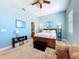 Stylish bedroom featuring a queen size bed, soft blue walls, and neutral carpet at 362 Coquina Dr, Tarpon Springs, FL 34689