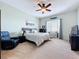 Bright bedroom featuring a queen-size bed, ocean themed decor, and a ceiling fan at 362 Coquina Dr, Tarpon Springs, FL 34689