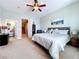 Comfortable bedroom with closet, carpeting, ceiling fan, and a view of the stairs at 362 Coquina Dr, Tarpon Springs, FL 34689