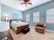 Stylish bedroom featuring a queen size bed, soft blue walls, and bright natural light at 362 Coquina Dr, Tarpon Springs, FL 34689