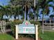 Clearwater's Best Beach sign surrounded by palm trees and lush greenery in a sunny, inviting setting at 362 Coquina Dr, Tarpon Springs, FL 34689