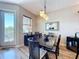 Elegant dining room featuring a large table, stylish lighting, and easy access to the outdoor balcony at 362 Coquina Dr, Tarpon Springs, FL 34689
