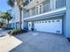 Charming blue condo boasts an attached garage, lovely landscaping and a welcoming entryway at 362 Coquina Dr, Tarpon Springs, FL 34689
