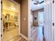 Hallway view of a bathroom with modern fixtures and a living room with balcony access at 362 Coquina Dr, Tarpon Springs, FL 34689